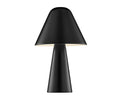The Muga Table Lamp, in black, features a modern design with a conical base and a wide cone-shaped shade. The lamp is illuminated, casting a soft glow beneath the shade, set against a plain white background.