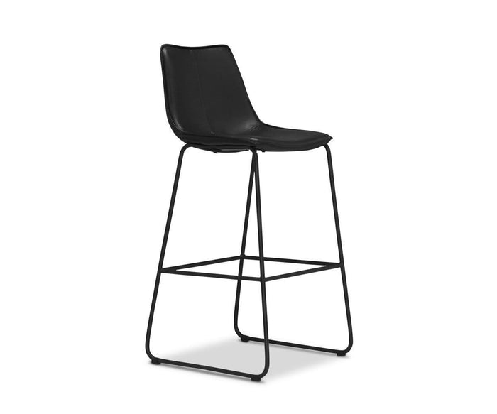 The Oken Bar Stool is a modern black minimalist bar stool featuring a curved seat, slender metal legs, and a footrest, photographed against a white background.