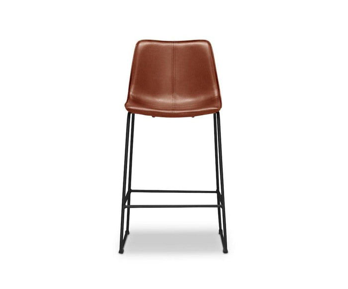 The Oken Counter Stool in Saddle features a modern design with a curved seat and backrest upholstered for comfort, supported by sleek black metal legs and footrests, shown against a white background.