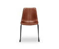 The Oken Dining Chair in saddle leather, featuring black metal legs, is shown from the front against a white background.