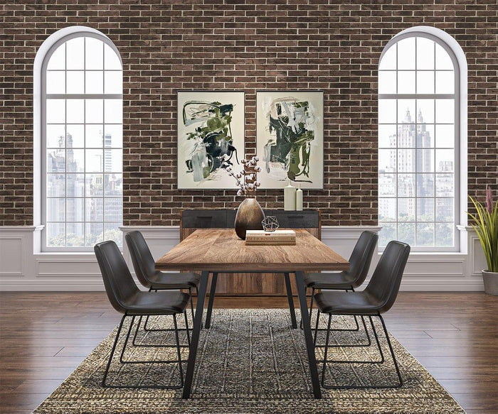 Modern dining room with a wooden table, six Oken Dining Chairs featuring sleek black finishes, a decorative vase centerpiece, two abstract paintings, large arched windows, brick walls, and a plant in the corner on a patterned rug.
