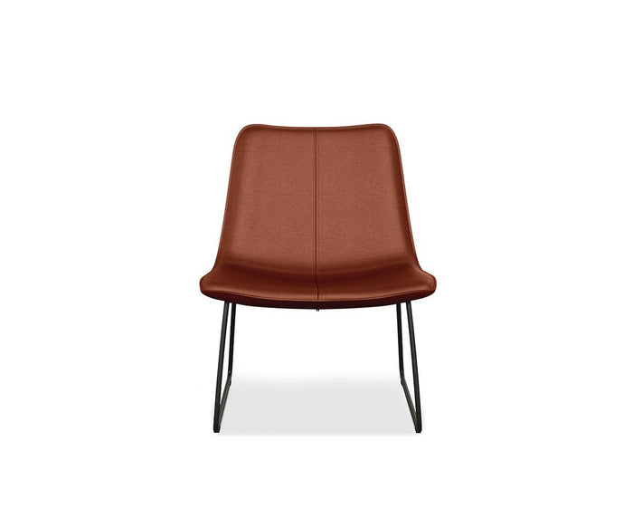 The Oken Lounge Chair showcases saddle leather upholstery with a curved backrest and black metal sled legs, set against a white background—an ideal choice for comfortable seating in any contemporary space.