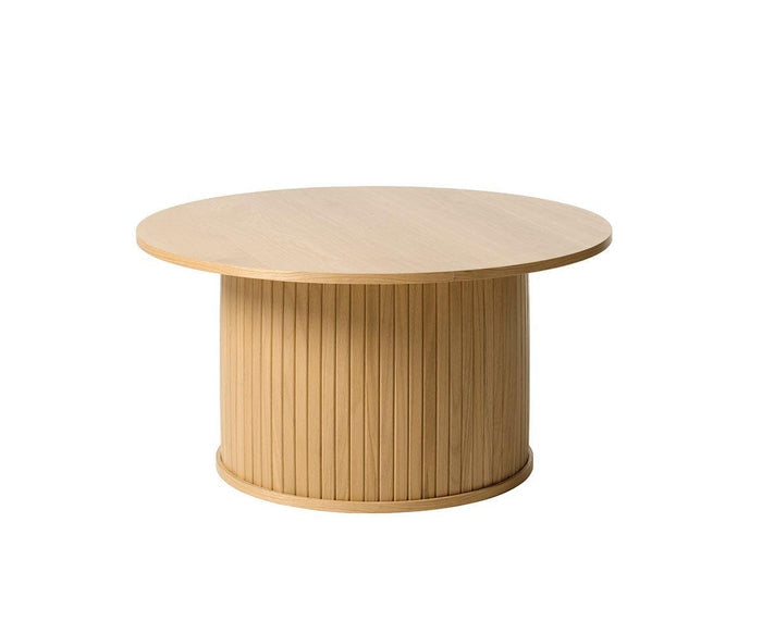 The Orella Round Coffee Table in Natural Oak Veneer features a smooth, circular top and a cylindrical base with vertically ribbed tambour paneling, displayed against a white background.