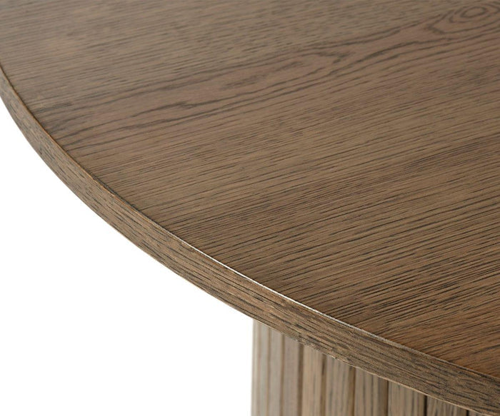 Close-up of the Orella Round Coffee Table reveals its intricate wood grain and smooth, polished surface with a slightly beveled edge—perfect for adding warmth and style to any modern living room.