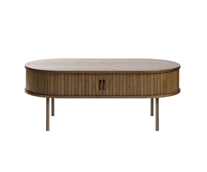 Oval wooden coffee table in a walnut veneer finish, featuring vertical slatted sides reminiscent of tambour paneling, two central handles on cabinet doors, and four straight legs—a stylish Orella Storage Coffee Table perfect for any modern living room.