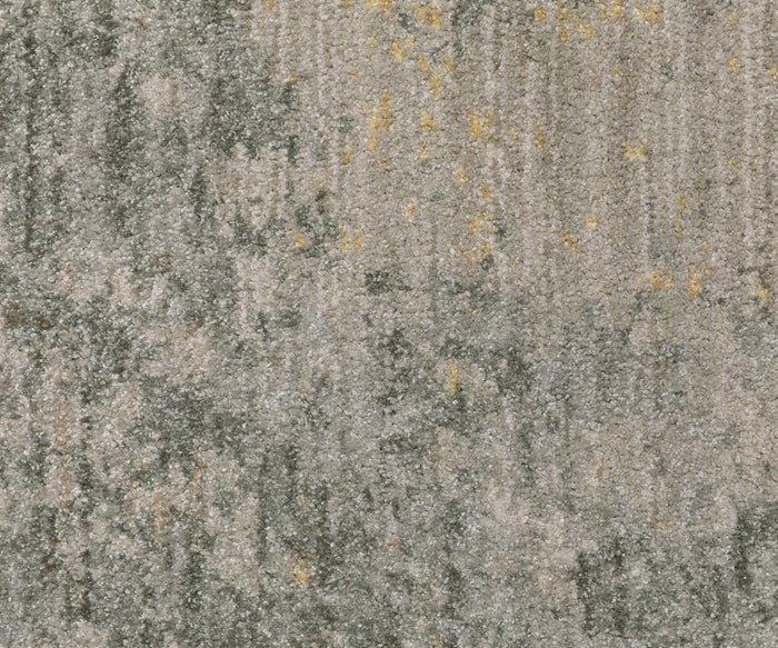 Close-up of the Oriental Weaver Mallory / MAL02 Rug surface, featuring a mottled, abstract pattern with a blend of gray, beige, and subtle yellow tones. Expertly power-loomed from space dyed polypropylene, this organic-pattern rug delivers both striking visual interest and lasting durability.