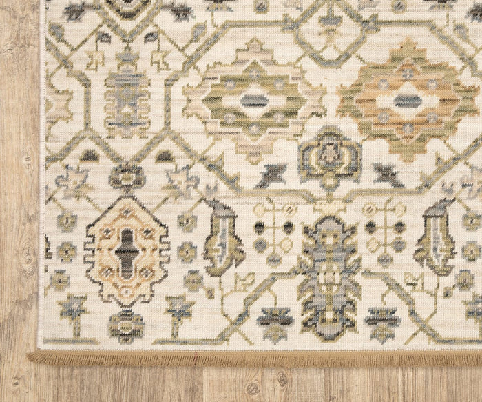 A close-up of the rectangular Oriental Weavers Acacia / ACA11 Rug showcases its intricate geometric patterns in beige, olive, grey, and tan hues on a wooden floor. Featuring a fringe along one edge, this boho-style rug offers an artisanal accent to its modern design.