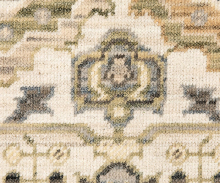 Close-up of the Oriental Weavers Acacia / ACA11 Rug, showcasing geometric shapes and floral motifs in muted beige, blue, and green tones. The fabric’s texture highlights the intricate craftsmanship reminiscent of designs woven on an Axminster loom.