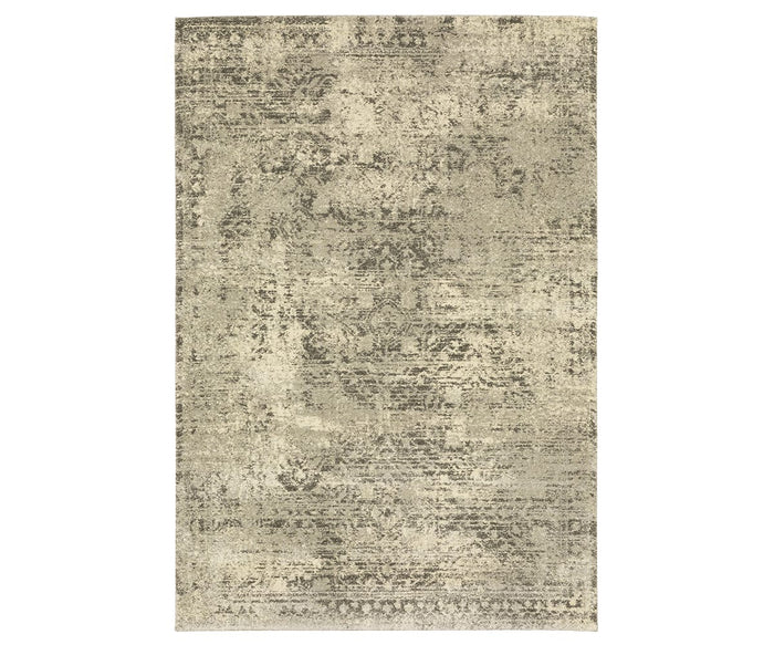 The Oriental Weavers Astor / 1806Q Rug is a rectangular area rug from the Astor Collection, showcasing a distressed, vintage-inspired motif in beige and multi colors. Its plush pile lends an antique, textured appearance with a worn look.