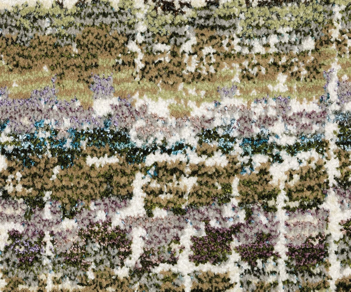 Close-up of the Oriental Weavers Atlas / 747A Rug, showcasing its textured surface with an abstract, uneven pattern in green, brown, white, blue, and purple tones—expertly machine-woven for durability and ideal for high-traffic areas.