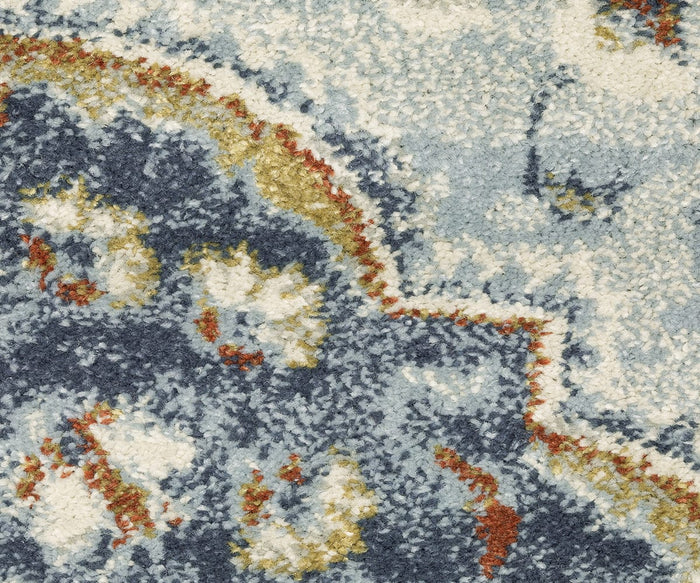 Close-up of the Oriental Weavers Branson / BR01A Rug, showcasing a patterned surface in blue, beige, gold, and rust tones. The design highlights abstract, curved shapes with slight texture, merging modern motifs with traditional rug aesthetics. This power-loomed piece effortlessly blends contemporary style and timeless elegance.