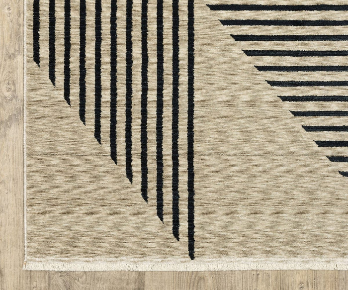 A corner of the Oriental Weavers Capella / CAP04 Rug is shown in the image, displaying its modern geometric design with black diagonal and parallel lines forming striking patterns on a beige space-dyed polyester background. The rug is placed on a light wood floor.