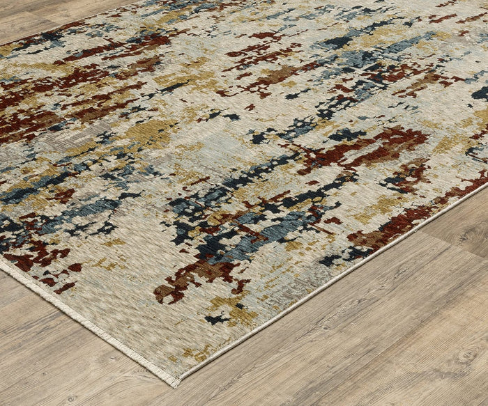 An Oriental Weavers Capella / CAP11 Rug with an abstract pattern in blue, red, gold, and beige tones lies on a light wood floor, featuring space-dyed polyester fibers for enhanced depth and color variation.