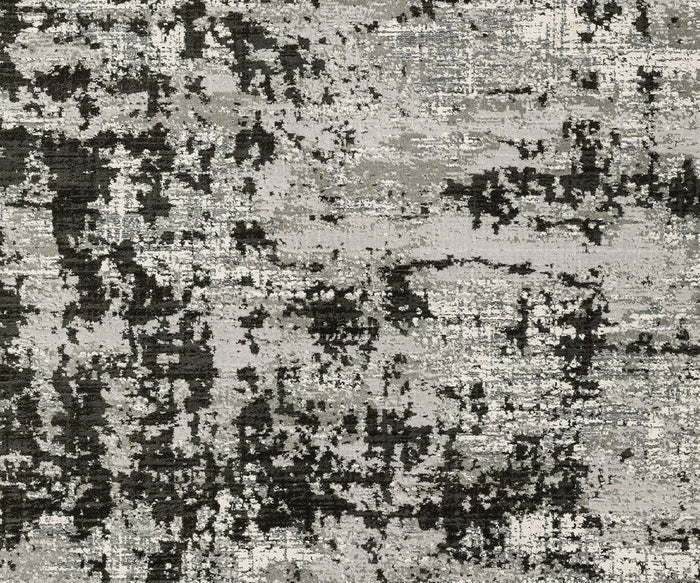 Featuring an abstract pattern of black, gray, and white with a textured, distressed look reminiscent of paint splatters or a weathered surface, the Oriental Weavers Caravan 4153Q Rug from the Caravan Collection is crafted in space-dyed polyester for style and durability inspired by nature.