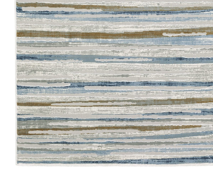 Introducing the Oriental Weavers Easton 4514E Rug, a rectangular piece from the Easton Collection. This rug showcases horizontal stripes in a range of blue, beige, gray, and white tones with an abstract, watercolor-inspired aesthetic. Crafted from durable polypropylene for lasting style and easy care, its seamlessly repeating pattern brings modern texture to any space.