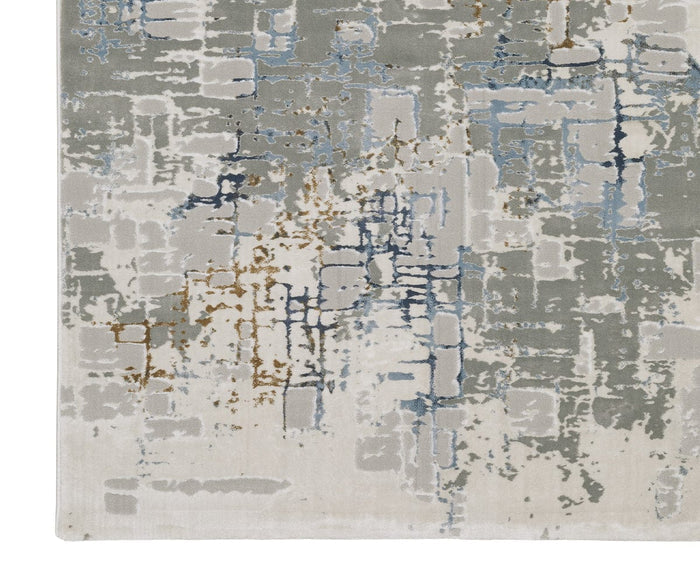 The Oriental Weavers Easton 8111X Rug from the Easton Collection features a modern, distressed pattern in shades of gray, beige, blue, and brown. Power-loomed from polypropylene, this area rug displays overlapping lines and blocks for a layered, textured look.
