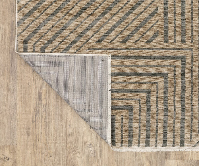 A corner of the Oriental Weavers Echo ECH01 Rug, power-loomed in Egypt, is folded over to show the backing. The rug showcases brown and gray diagonal lines in a geometric pattern, elegantly placed on a light wood floor.