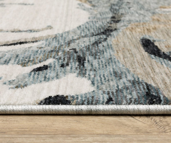 Close-up of the edge of the Oriental Weavers Echo / ECH07 Rug, featuring shades of gray, cream, and black, placed on a light wood floor. Made in Egypt, the power-loomed texture and fibers of the rug are clearly visible.