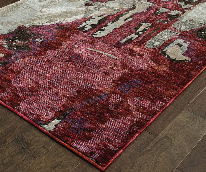 A close-up of the Oriental Weavers Evolution / 8028B Rug showcases its modern abstract patterns in red, burgundy, and beige tones, woven in the USA from a durable nylon polypropylene blend and placed on a dark wooden floor.