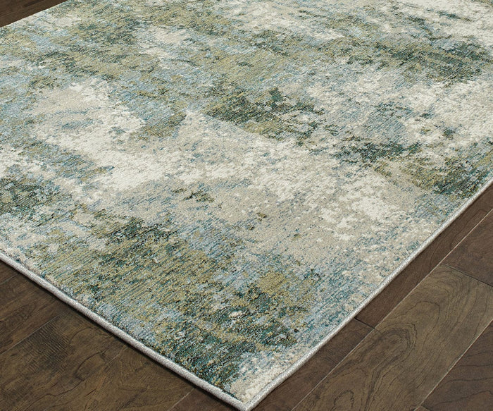 The Oriental Weavers Evolution / 8039E Rug is a rectangular area rug that showcases an abstract pattern in green, blue, and cream tones atop a dark wooden floor. Crafted from durable nylon, this rug offers a textured appearance and features a slim, light-colored border. Its easy maintenance and contemporary style make it a perfect addition to any modern space.