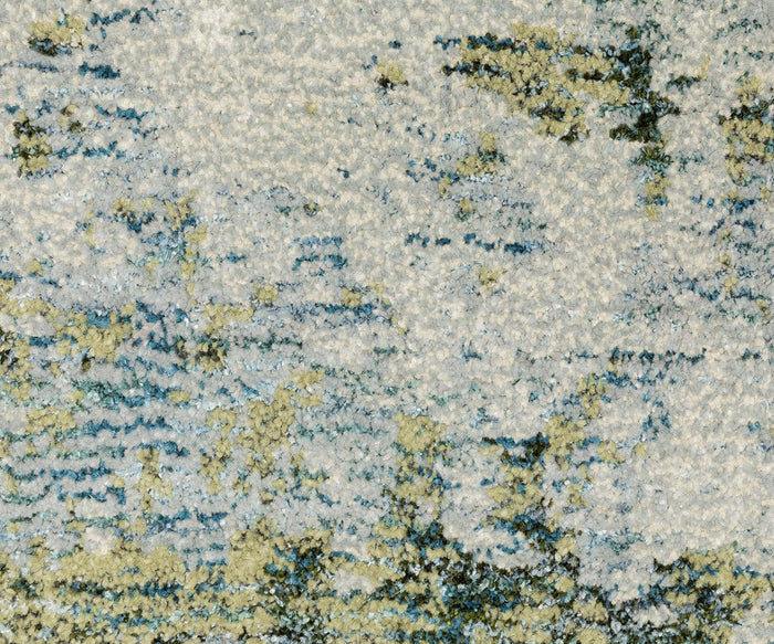 Close-up of the Oriental Weavers Evolution / 8039E Rug, featuring a textured surface with a mottled pattern in cream, blue, green, and yellow shades for an abstract, watercolor-like look. Crafted from durable nylon fibers, this rug is also easy to maintain for everyday living.