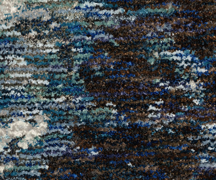 Close-up of the Oriental Weavers Evolution / 962A Rug, featuring a textured, multicolored fabric from the Evolution Collection. Shades of blue, brown, gray, and white are woven together in an abstract, irregular pattern. Crafted from durable nylon, this rug combines easy maintenance with stylish design and lasting quality.