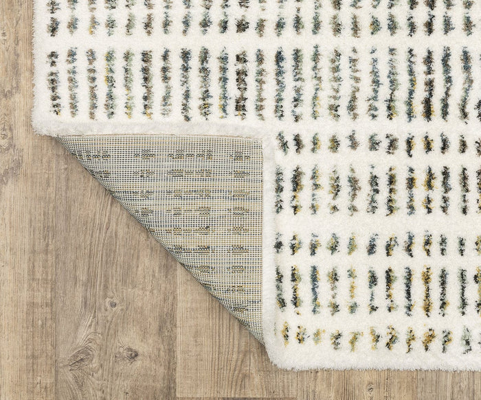 The Oriental Weavers Galileo GAL02 Rug, showcasing a vibrant multicolored abstract line design, is partially flipped to display its dense pile and textured backing. Crafted from microfiber polyester, this rug rests elegantly on a light wood floor.