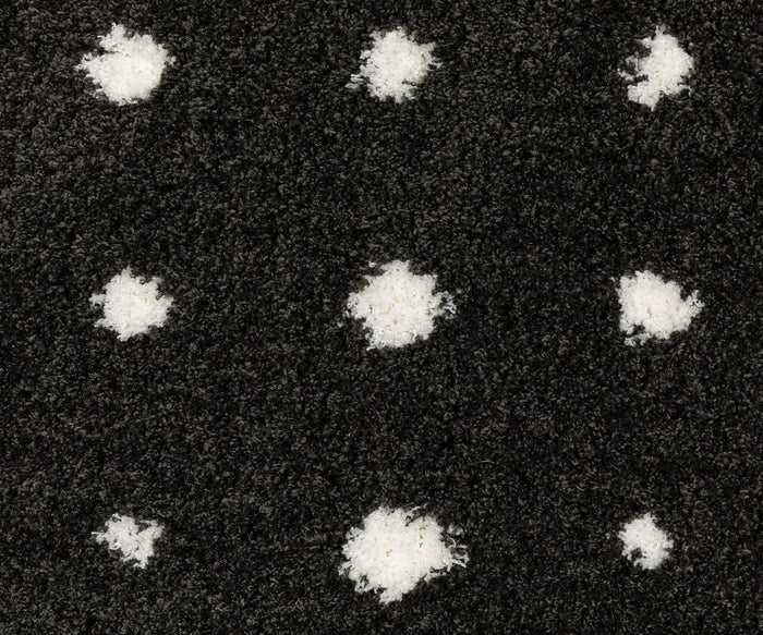 Close-up of a black textured surface with a grid of slightly irregular white spots, resembling a polka dot pattern—much like the stylish design featured on the Oriental Weavers Galileo / GAL04 Rug.