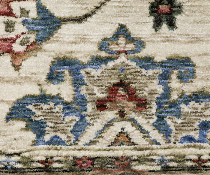 A close-up of the Oriental Weavers Hastings / HA03W Rug reveals a traditional multicolor area rug, adorned with intricate blue, red, and beige designs featuring symmetrical shapes and floral motifs on a cream background. Crafted from space-dyed polyester, this rug beautifully highlights detailed craftsmanship and vibrant hues.