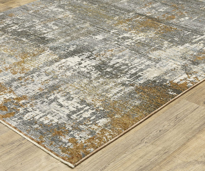 A close-up of the Oriental Weavers Hayden HAY06 Rug, a space-dyed polyester piece displaying an abstract pattern in gray, beige, and mustard yellow tones, shown on a light wood floor.
