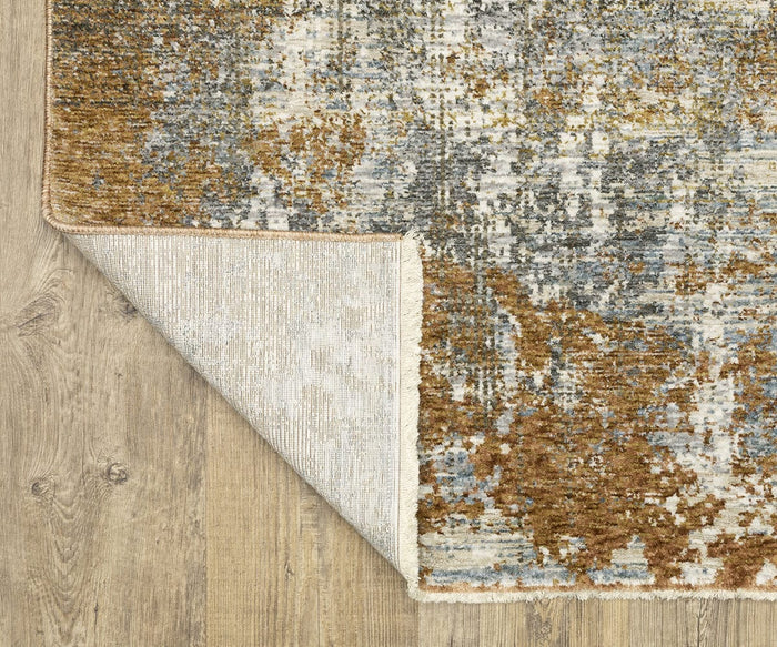 Corner of an Oriental Weavers Hayden HAY06 Rug in brown, gray, and cream tones on a light wood floor, with one corner flipped to reveal the backing—the rug features space-dyed polyester for a modern twist on classic style.