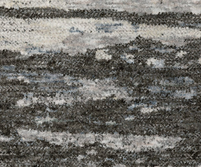 The Oriental Weavers Hayden / HAY07 Rug features a textured surface crafted from space-dyed polyester, showcasing a mottled pattern in shades of gray, black, white, and subtle hints of blue for an abstract, cloud-like or stone-inspired look.