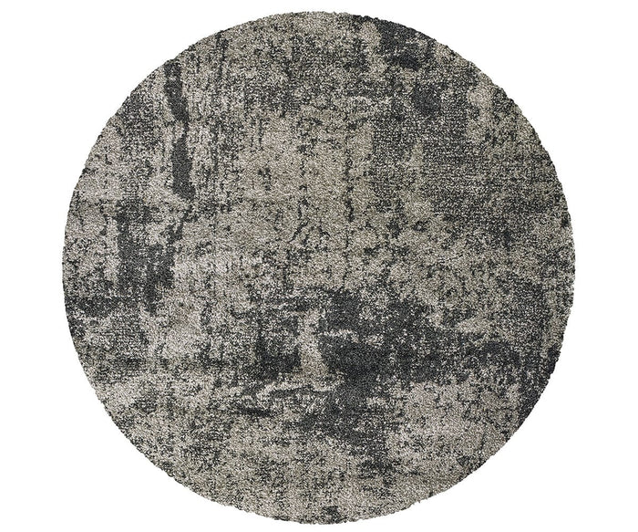 The Oriental Weavers Henderson / 5503Z Rug is a round area rug featuring a textured, abstract pattern in grey and multi-color tones. Its mix of neutral shades creates a contemporary look with light and dark patches spread throughout the surface.