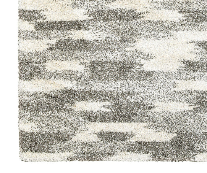 Close-up of a rectangular Oriental Weavers Henderson / 565J Rug corner with a high-pile texture, featuring an abstract pattern in shades of gray and cream—perfect for those seeking modern geometric rug style among neutral area rugs.