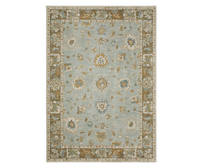 The Oriental Weavers Maeve / MAE06 Rug in Beige/Multi showcases a rectangular Persian-inspired design, featuring a light blue center adorned with intricate floral patterns and a wide olive-green border with matching motifs. Crafted from space dyed polypropylene, this boho rug offers vibrant style and lasting durability for any room.