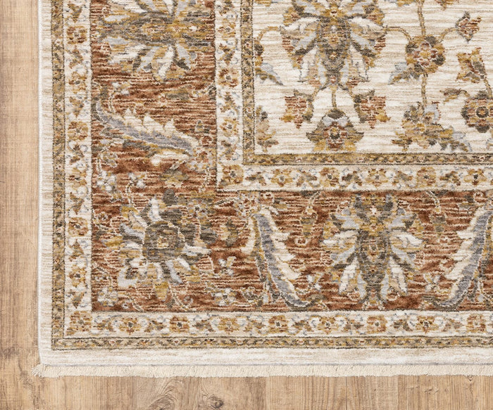 Corner of an Oriental Weavers Maharaja / 5091Q Rug featuring beige, brown, and gold floral patterns on a wooden floor. This durable polyester rug includes a detailed border and fringe trim, highlighting classic traditional designs.