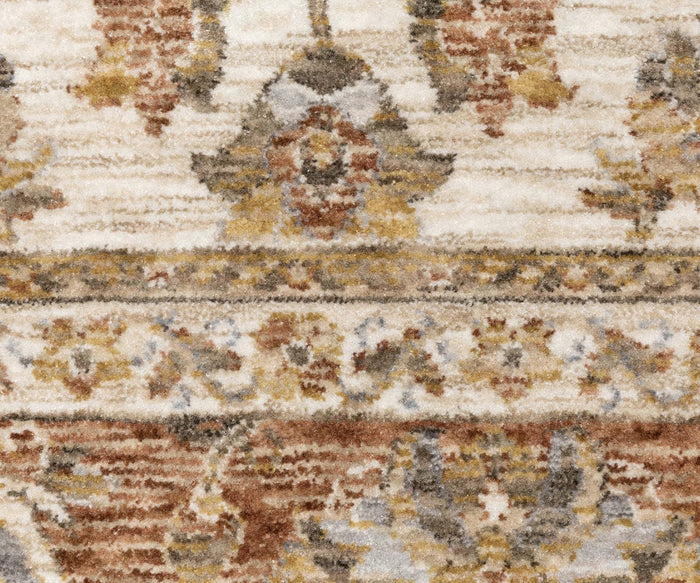 Close-up of the Oriental Weavers Maharaja / 5091Q Rug, featuring traditional designs in beige, brown, gold, and gray with ornate, symmetrical floral and geometric patterns. The texture of the durable polyester material is clearly visible.