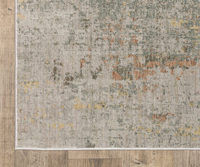 The Oriental Weavers Mallory / MAL05 Rug, a rectangular piece from the Mallory Collection, features an abstract pattern in earthy shades of muted green, brown, yellow, and beige crafted from space-dyed polypropylene and is elegantly placed on a light wood floor.