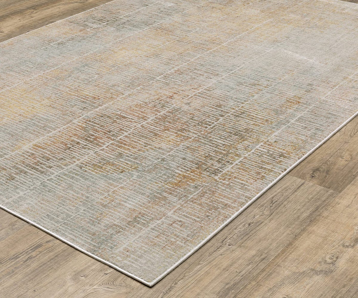 The Oriental Weavers Mallory / MAL09 Rug is a rectangular area rug, power-loomed from space-dyed polypropylene, showcasing a subtle abstract pattern in muted beige, gray, and light brown hues. Ideally suited for placement on a light wood floor, it brings an understated yet contemporary feel to any space.