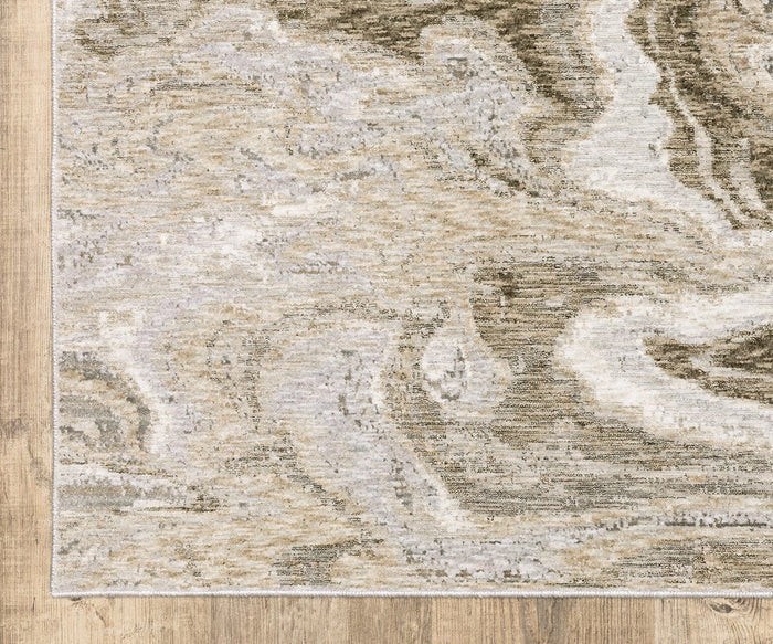 Corner of the Oriental Weavers Nebulous / 530E Rug, showcasing its beige and gray marbled pattern on a light brown wooden floor. This rug features subtle swirling designs in neutral tones with an abstract texture, expertly crafted from soft polyester yarn for both style and comfort.