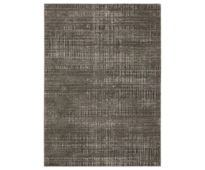 The Oriental Weavers Nebulous / 751D Rug features a rectangular shape with a textured, woven look in versatile brown and multi-toned shades. Subtle irregular white lines and a distressed, modern pattern add visual interest to this abstract design from the Nebulous Collection. Crafted from space-dyed polyester, it offers rich color variation and lasting durability.