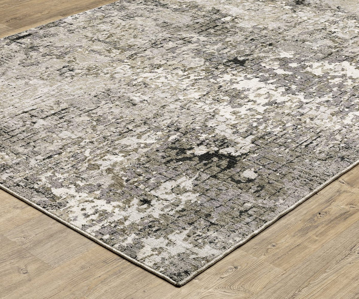 A close-up of the Oriental Weavers Nebulous / 91D Rug showcases its rectangular shape and distressed abstract pattern in beige, gray, black, and white tones. Crafted from soft polyester yarn, this area rug is displayed on a light wood floor.