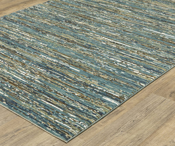 The Oriental Weavers Reed / RE01G Rug features an abstract design with blue, brown, beige, and white streaks set atop light wood flooring. This modern area rug showcases a textured pattern of horizontal lines and blended colors, expertly crafted from space-dyed polypropylene for exceptional durability and vibrant style.