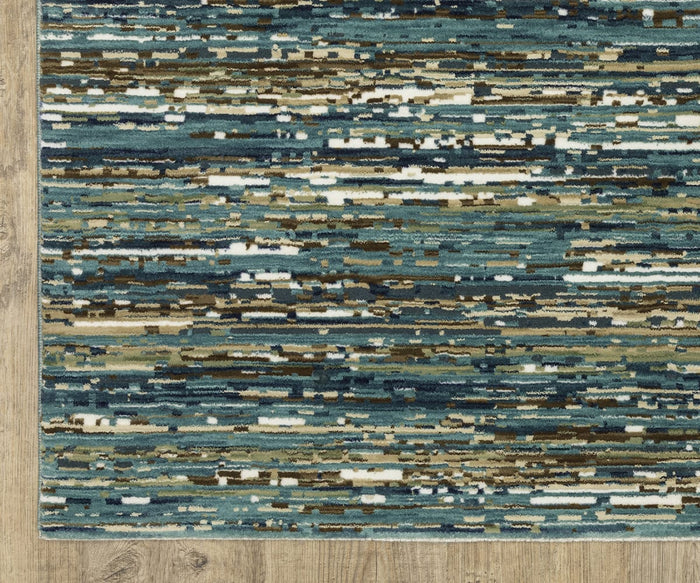 The Oriental Weavers Reed / RE01G Rug showcases an abstract, horizontal pattern in blue, teal, beige, brown, and white tones on a light wooden floor. Crafted from space-dyed polypropylene, this textured rectangular rug features brush stroke–like or static-inspired lines for a contemporary appearance.
