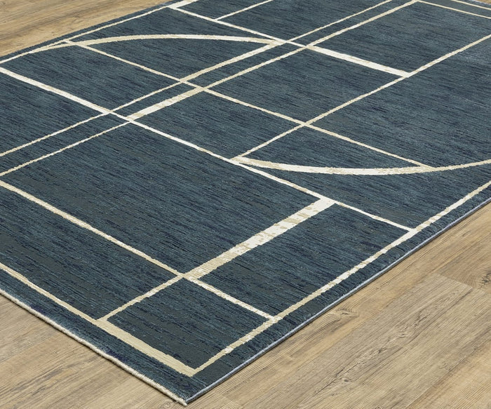 An Oriental Weavers Reed / RE04B Rug in blue, adorned with white geometric lines and shapes, rests on a light wood floor. Crafted from space-dyed polypropylene, this rug showcases intersecting straight and curved lines that create rectangles and arcs for a modern look.