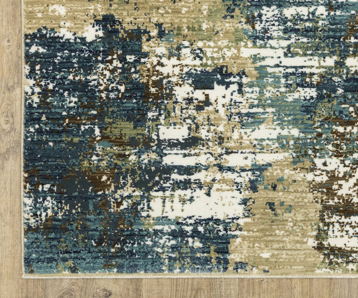 The Oriental Weavers Reed / RE06A Rug showcases an abstract pattern with blue, green, beige, brown, and white color blocks blending together. Placed on a light wood floor, this rectangular rug features a modern design and textured surface. Skillfully crafted from space-dyed polypropylene, it offers both visual depth and lasting durability.