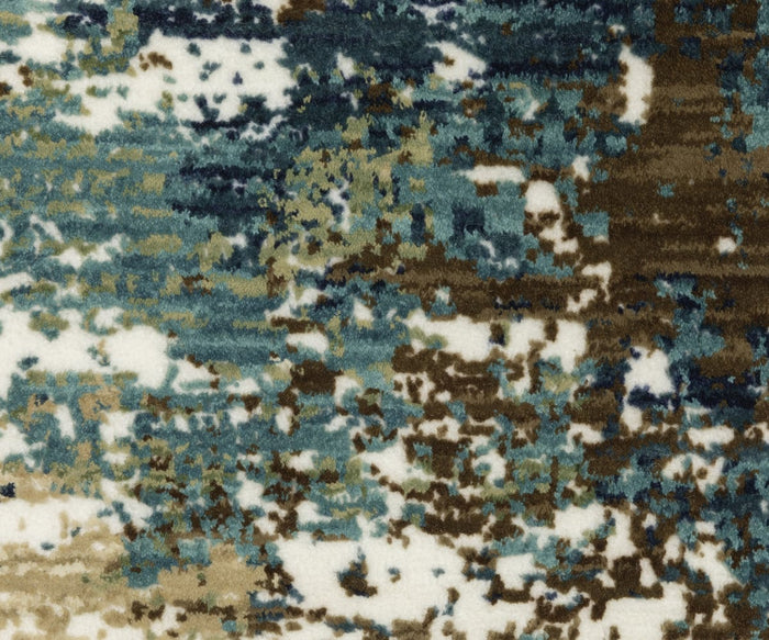 The Oriental Weavers Reed / RE06A Rug features an abstract pattern with splashes of blue, green, brown, and white, reminiscent of a watercolor painting with softly blended edges and varied textures across the surface. Expertly crafted from space-dyed polypropylene, this textured rug offers both striking visual appeal and lasting durability.