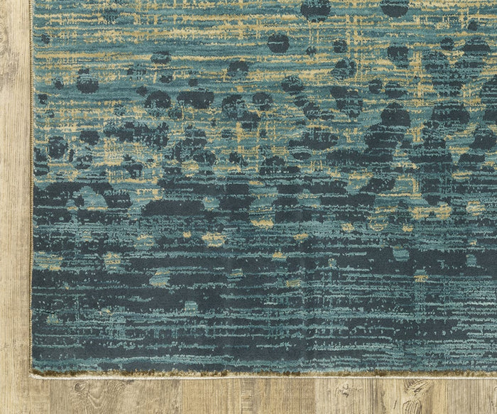 The Oriental Weavers Reed / RE08A Rug, featuring a rectangular shape and a modern blue and yellow abstract textured pattern, sits on a light wood floor.