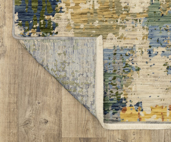 A corner of the Oriental Weavers Soleri / SOL01 Rug, featuring a multicolored pattern, is folded over on a light wood floor, revealing both the rug’s intricately designed top side and its textured underside.