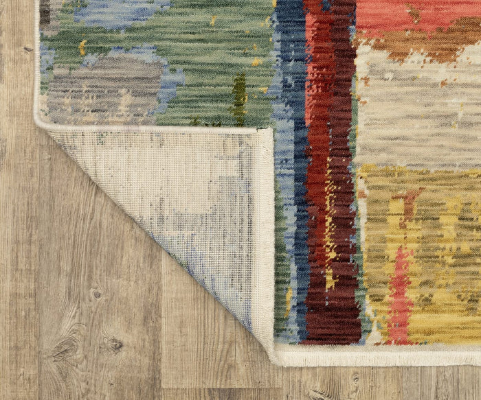 A close-up of a corner of the colorful, modern Oriental Weavers Soleri / SOL02 Rug with its edge flipped over to reveal the underside. This rug is crafted from a wool nylon blend and rests elegantly on a light wood floor.